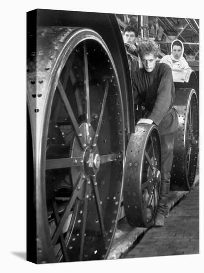 Workers Standing Amidst Large Metal Wheel Frames on Tractorstroi Tractor Factory Assembly Line-Margaret Bourke-White-Premier Image Canvas