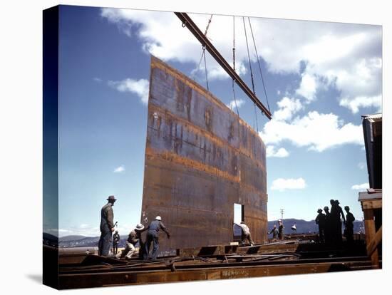 Workers Watching as Steel Beam is Raised High Above During Sub Assembling of Ship at Shipyard-Hansel Mieth-Premier Image Canvas
