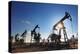 Working Oil Pumps Silhouette against Sun-Kokhanchikov-Premier Image Canvas