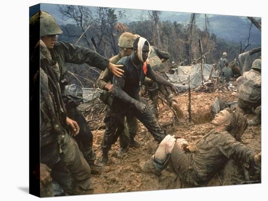 Wounded Marine Gunnery Sgt. Jeremiah Purdie During the Vietnam War-Larry Burrows-Premier Image Canvas