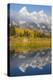 Wyoming, Grand Teton NP. Grand Teton with fresh snow is reflected in a pond with autumn cottonwoods-Elizabeth Boehm-Premier Image Canvas