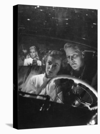 Young Couple Snuggling in Convertible as They Intently Watch Movie at Drive-in Movie Theater-J^ R^ Eyerman-Premier Image Canvas