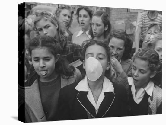 Young Girl Blowing a Bubble with Her Friends Watching-Bob Landry-Premier Image Canvas