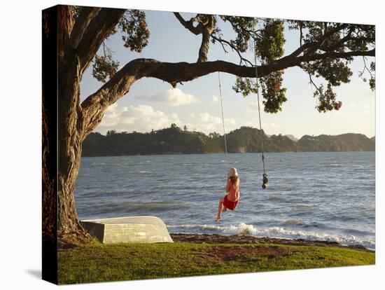 Young Girl on Rope Swing under Pohutukawa Tree, Oamaru Bay, Coromandel, North Island, New Zealand-David Wall-Premier Image Canvas