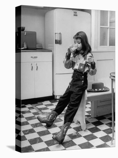 Young Girl Wearing Cowgirl Outfit Drinking Milk and Eating Sandwich in Kitchen-Nina Leen-Premier Image Canvas