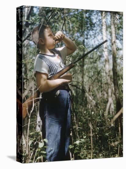 Young Hunter Blowing a Duck Decal Wistle while Holding His Rifle under His Arm-Al Fenn-Premier Image Canvas