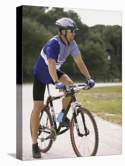 Young Man Sitting on a Bicycle-null-Premier Image Canvas