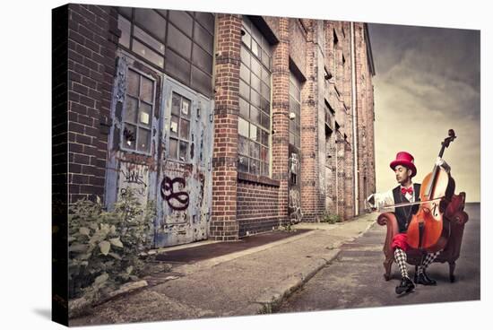 Young Man Sitting On An Armchair On A City Street And Playing The Cello-olly2-Stretched Canvas