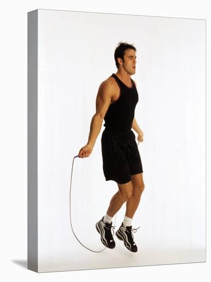 Young Man Working Out with Jump Rope-Chris Trotman-Premier Image Canvas