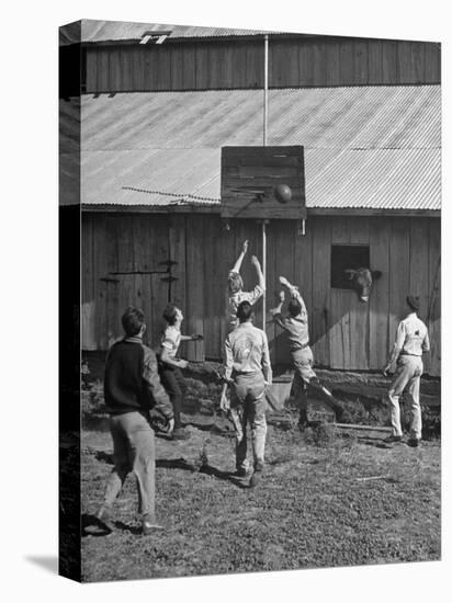 Young Men Playing Basketball with a Homemade Basket in a Farmyard-null-Premier Image Canvas
