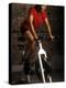 Young Woman Exercising on a Stationary Bike-null-Premier Image Canvas