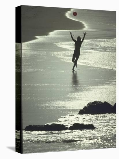 Young Woman in Silhouette Running Along Beach at Twilight Throwing Beach Ball Up in the Air-Co Rentmeester-Premier Image Canvas
