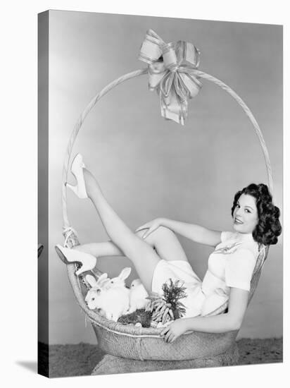 Young Woman, Looking Like a Present, Sitting in Gift Basket with Bunnies-null-Stretched Canvas