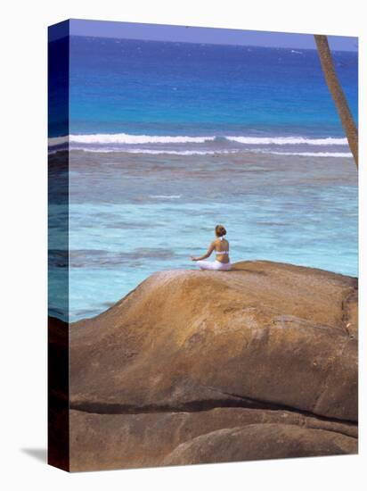 Young Woman Meditating on Rock, Seychelles, Indian Ocean, Africa-Sakis Papadopoulos-Premier Image Canvas