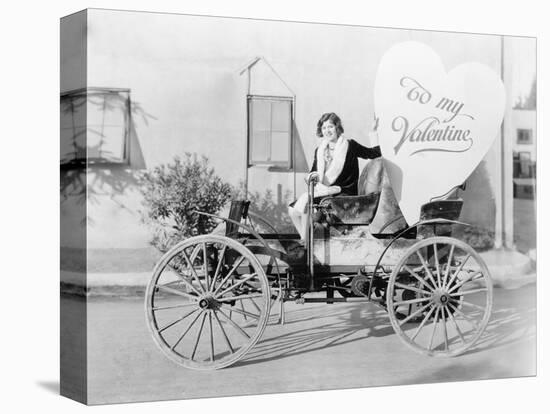 Young Woman Sitting on a Car Holding a Big Heart Shaped Sign-null-Stretched Canvas