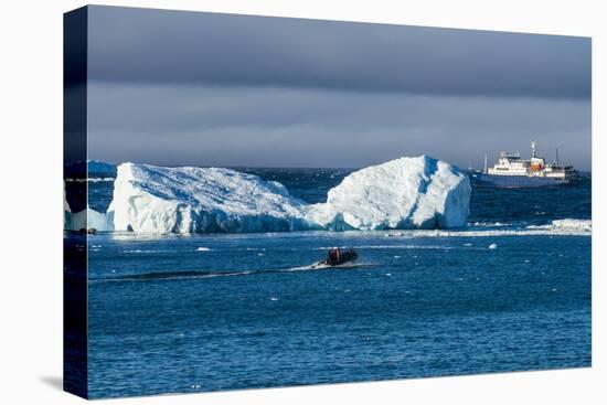 Zodiac cruising back to a cruise ship anchoring behind an iceberg, Brown Bluff, Antarctica, Polar R-Michael Runkel-Premier Image Canvas