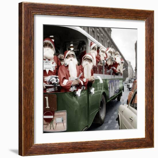 100 Santa Claus in a Special Bus in Paris December, 19, 1966. Colorized Document-null-Framed Photo