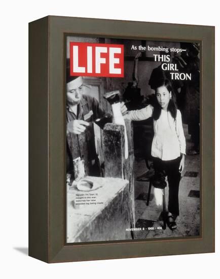 12-Year-Old Vietnamese Girl Nguyen Thi Tron Watching New Wooden Leg Being Made, November 8, 1968-Larry Burrows-Framed Premier Image Canvas