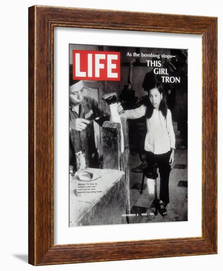 12-Year-Old Vietnamese Girl Nguyen Thi Tron Watching New Wooden Leg Being Made, November 8, 1968-Larry Burrows-Framed Photographic Print