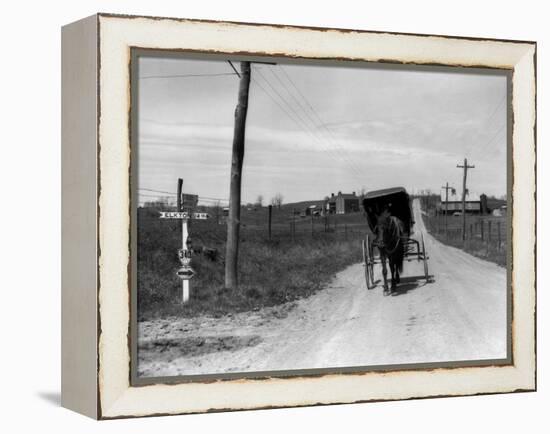 1920s-1930s Amish Man Driving Buggy Down Rural Dirt Road in Farm Country-null-Framed Premier Image Canvas