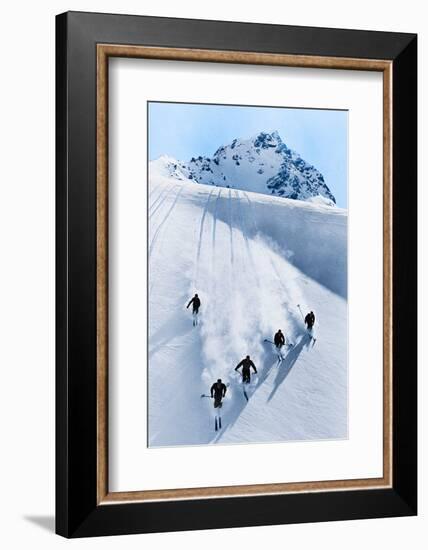 1920s 1930s FIVE ANONYMOUS MEN SKIING DOWN SNOW COVERED ALPS SWITZERLAND-H. Armstrong Roberts-Framed Photographic Print