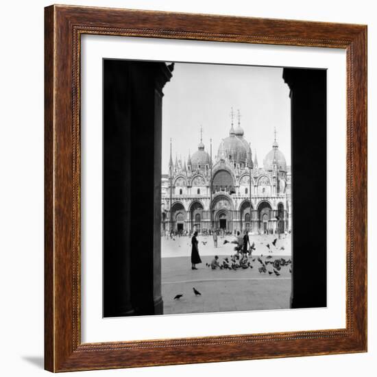 1920s 1930s VIEW THROUGH DOORWAY TO PEOPLE FEEDING PIGEONS IN FRONT OF ST. MARKS CATHEDRAL VENIC...-H. Armstrong Roberts-Framed Photographic Print
