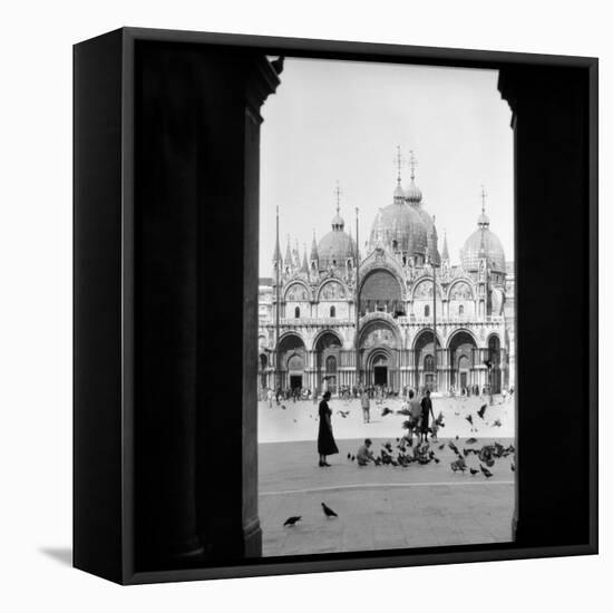1920s 1930s VIEW THROUGH DOORWAY TO PEOPLE FEEDING PIGEONS IN FRONT OF ST. MARKS CATHEDRAL VENIC...-H. Armstrong Roberts-Framed Premier Image Canvas