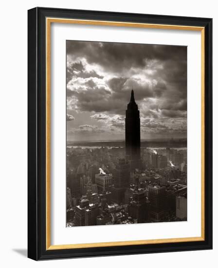 1930s-1940s Empire State Building Silhouetted Against High Gathering Storm Clouds Covering NYC-null-Framed Photographic Print