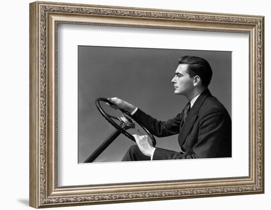 1930s 1940s MAN WEARING SUIT AND TIE DRIVING HANDS ON STEERING WHEEL-H. Armstrong Roberts-Framed Photographic Print