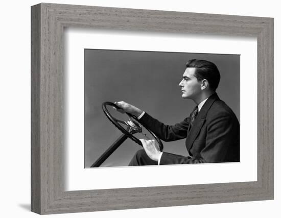 1930s 1940s MAN WEARING SUIT AND TIE DRIVING HANDS ON STEERING WHEEL-H. Armstrong Roberts-Framed Photographic Print
