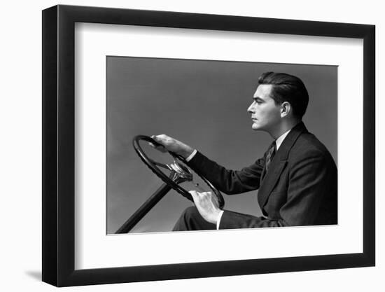 1930s 1940s MAN WEARING SUIT AND TIE DRIVING HANDS ON STEERING WHEEL-H. Armstrong Roberts-Framed Photographic Print