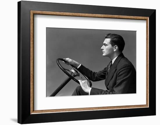 1930s 1940s MAN WEARING SUIT AND TIE DRIVING HANDS ON STEERING WHEEL-H. Armstrong Roberts-Framed Photographic Print
