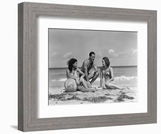1930s 1940s TWO WOMEN ONE MAN IN BATHING SUITS SITTING ON BEACH-Panoramic Images-Framed Photographic Print