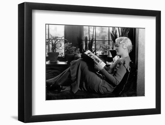 1930s BLOND WOMAN SITTING BY WINDOW READING MAGAZINE PROFILE VIEW PLANTS IN BACKGROUND WINDOW SEAT-H. Armstrong Roberts-Framed Photographic Print