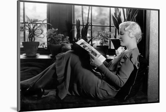 1930s BLOND WOMAN SITTING BY WINDOW READING MAGAZINE PROFILE VIEW PLANTS IN BACKGROUND WINDOW SEAT-H. Armstrong Roberts-Mounted Photographic Print