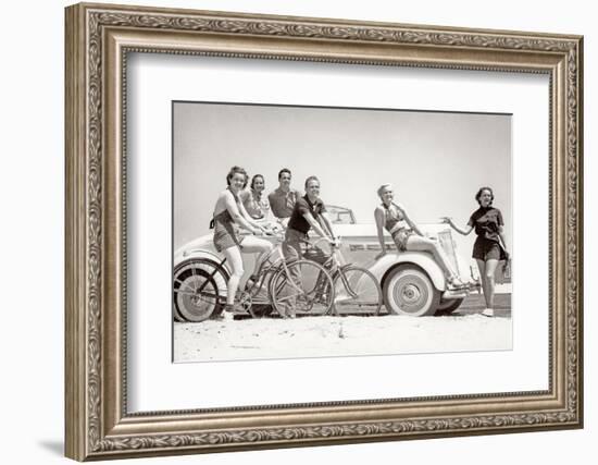 1930s GROUP OF MEN AND WOMEN WEARING BATHING SUITS CASUAL CLOTHES ON BICYCLES IN A CAR ON BEACH...-H. Armstrong Roberts-Framed Photographic Print