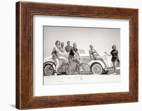 1930s GROUP OF MEN AND WOMEN WEARING BATHING SUITS CASUAL CLOTHES ON BICYCLES IN A CAR ON BEACH...-H. Armstrong Roberts-Framed Photographic Print