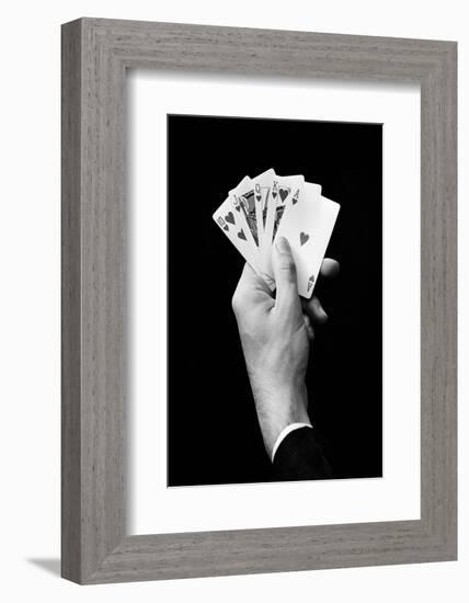 1930s MAN'S HAND HOLDING 5 PLAYING CARDS A POKER HAND THAT IS A ROYAL STRAIGHT FLUSH IN HEARTS-H. Armstrong Roberts-Framed Photographic Print