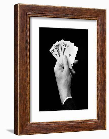 1930s MAN'S HAND HOLDING 5 PLAYING CARDS A POKER HAND THAT IS A ROYAL STRAIGHT FLUSH IN HEARTS-H. Armstrong Roberts-Framed Photographic Print