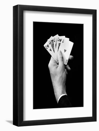 1930s MAN'S HAND HOLDING 5 PLAYING CARDS A POKER HAND THAT IS A ROYAL STRAIGHT FLUSH IN HEARTS-H. Armstrong Roberts-Framed Photographic Print