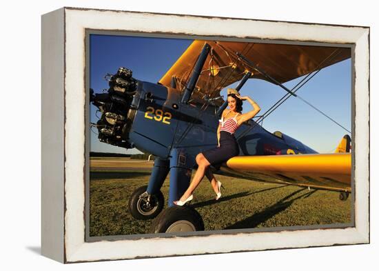 1940's Style Pin-Up Girl Sitting on the Wing of a Stearman Biplane-null-Framed Premier Image Canvas