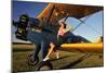 1940's Style Pin-Up Girl Sitting on the Wing of a Stearman Biplane-null-Mounted Photographic Print