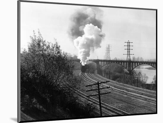 1940s Aerial of Train Traveling Along River under Bridge Billowing Smoke Near Columbus, Ohio-null-Mounted Photographic Print
