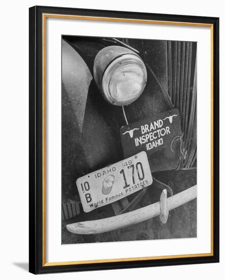 1949 Idaho License Plate Featuring a Buttered Baked Potato on a Cattle Brand Inspector's Car-null-Framed Photographic Print