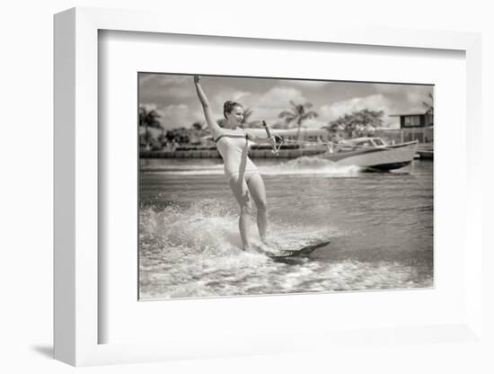 1950s EXCITED WOMAN WATER SKIING POWER BOAT SPEEDING IN BACKGROUND ON PALM TREE LINED CANAL MIAM...-H. Armstrong Roberts-Framed Photographic Print