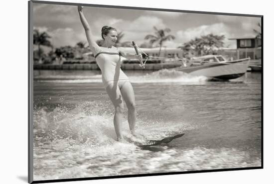 1950s EXCITED WOMAN WATER SKIING POWER BOAT SPEEDING IN BACKGROUND ON PALM TREE LINED CANAL MIAM...-H. Armstrong Roberts-Mounted Photographic Print