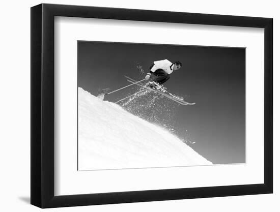 1950s MAN SKIER SKIING DOWN SLOPE JUMPING INTO AIR-H. Armstrong Roberts-Framed Photographic Print