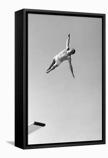 1950s MAN TWISTING SWAN DIVING FROM HIGH DIVING BOARD OUTDOOR-H. Armstrong Roberts-Framed Premier Image Canvas
