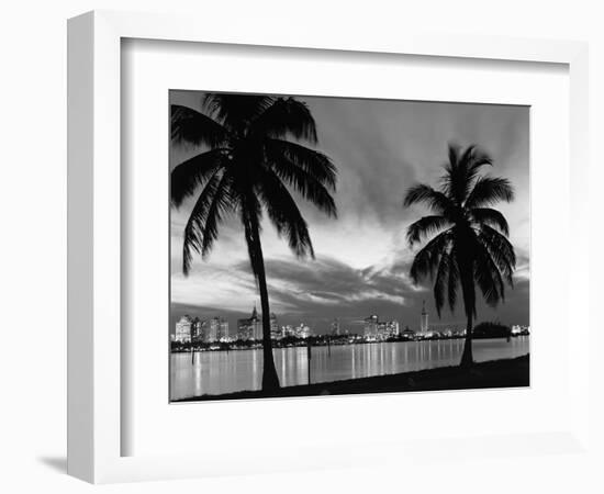 1950s Night Skyline View across the Bay Two Palm Trees Silhouetted in Foreground Miami, Florida-null-Framed Photographic Print