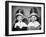 1950s TWO WOMEN SITTING UNDER BEAUTY SALON HAIR DRYERS WEARING HAIRNETS TOWELS TALKING GOSSIP-Panoramic Images-Framed Photographic Print